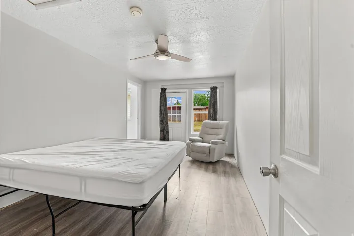 Light-toned wood-finish flooring complements white walls and ceiling