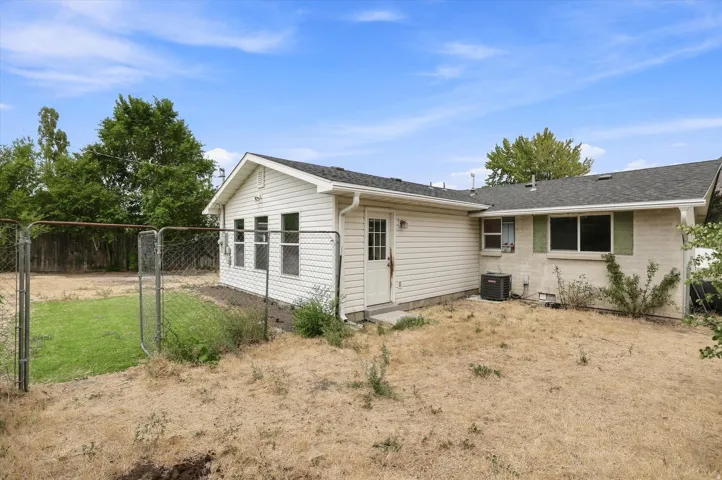 Expansive rear yard with a chain-link fence