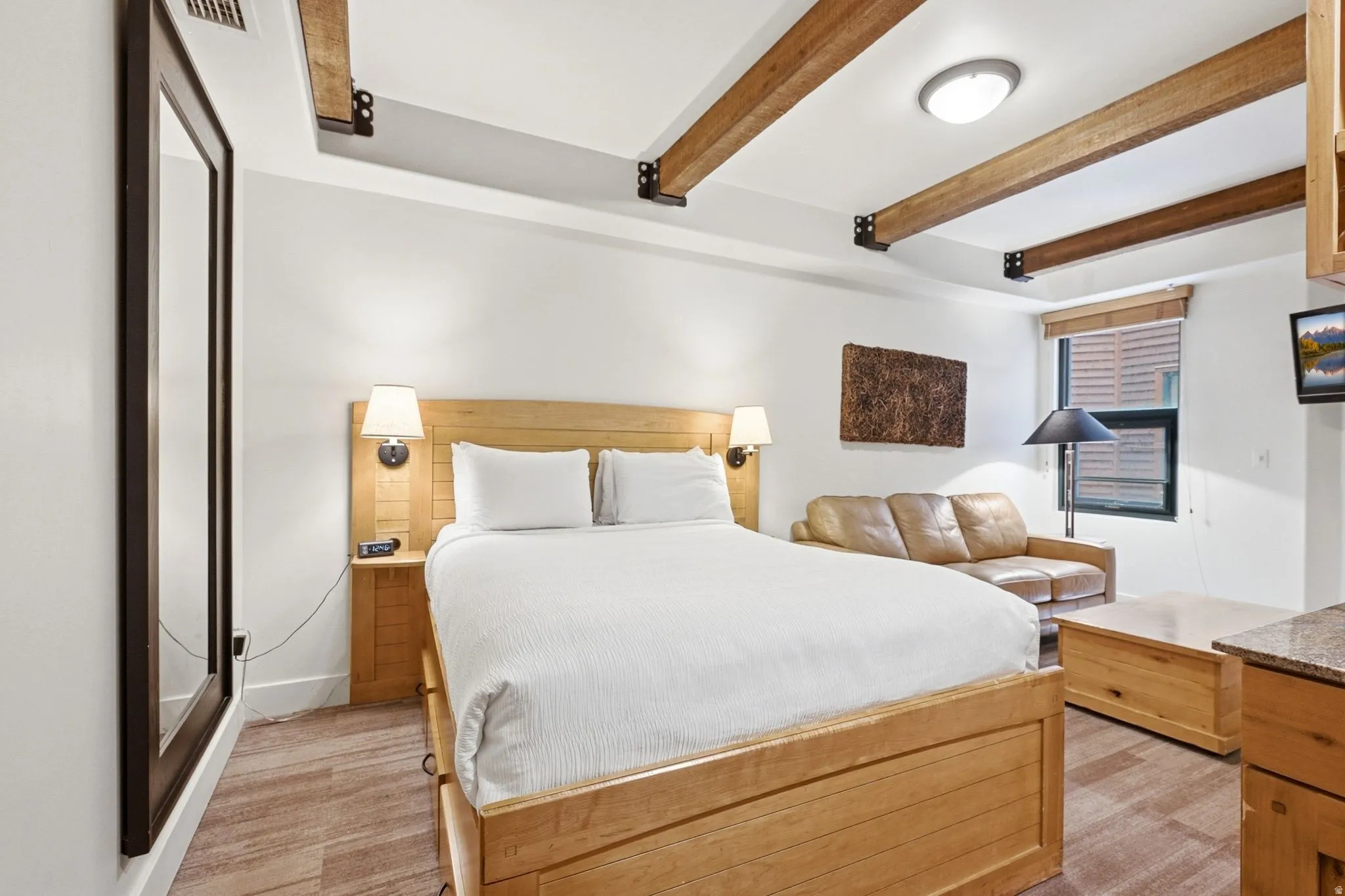 Exposed ceiling beams, wood-finish flooring, recessed lighting, and a window with blinds