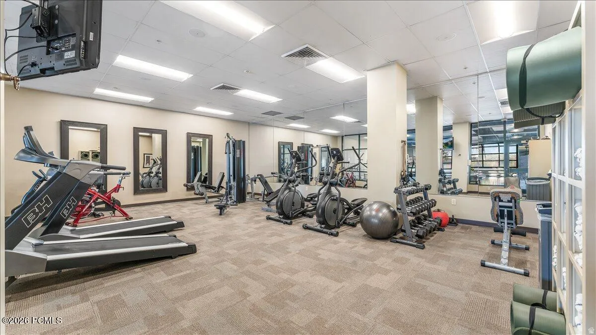 Fitness center featuring carpeted flooring and recessed lighting
