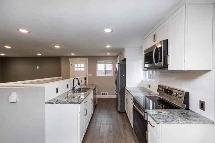 Kitchen with Granite Countertops and Included Stainless Steele Appliances
