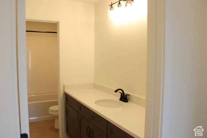 Dark wood-finish vanity with an integrated sink and light-toned countertop