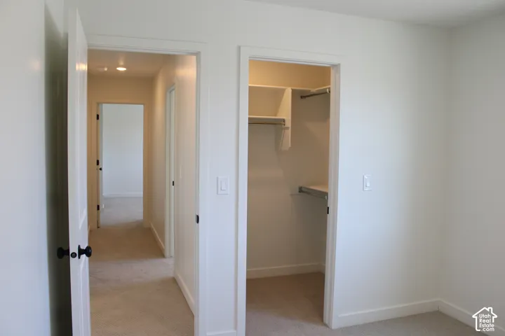 Hallway with recessed lighting and carpeted flooring