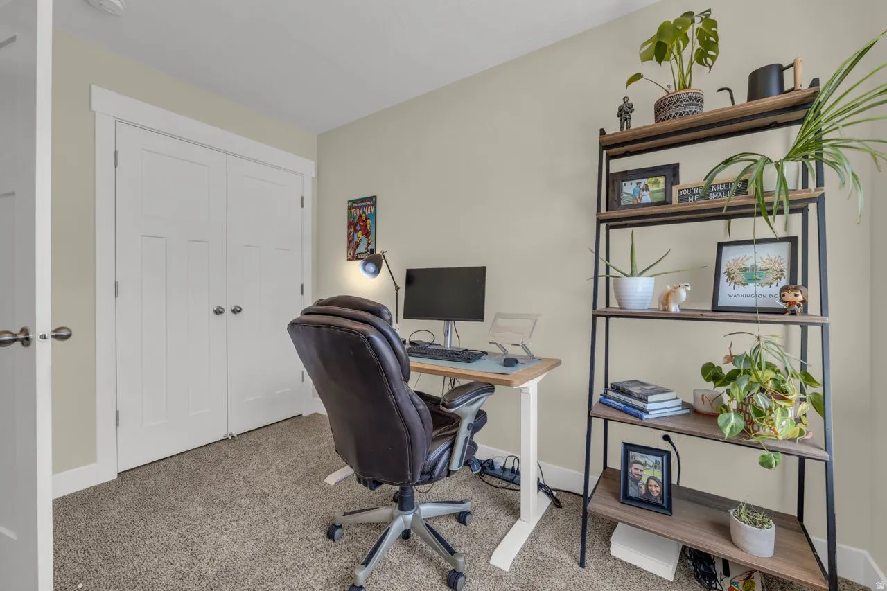Neutral wall paint, carpeted flooring, white trim, and a built-in closet with bifold doors