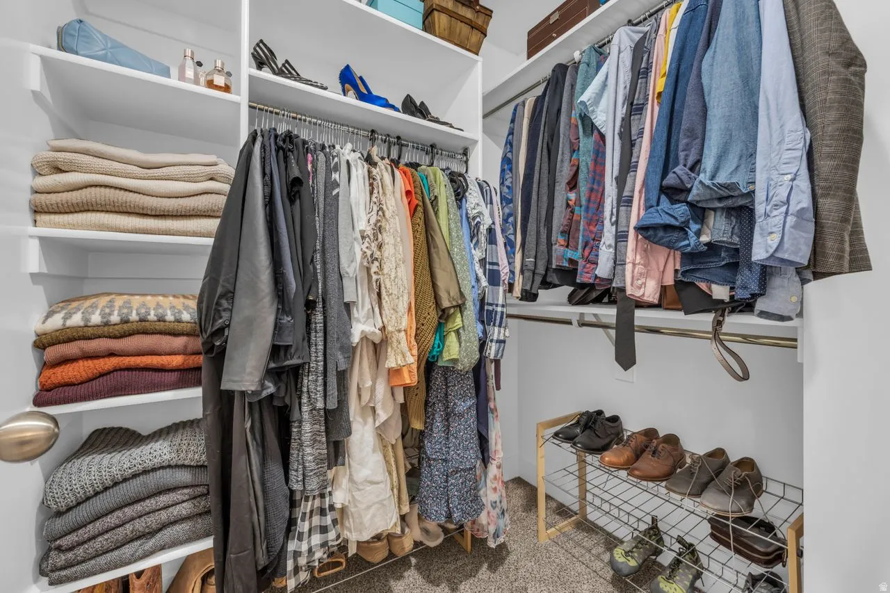 Custom closet system featuring multiple shelves, hanging rods, and an integrated shoe rack