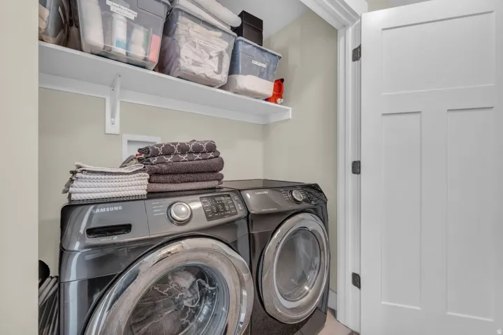 Integrated laundry area with upper shelving