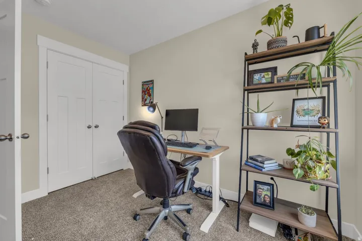 Neutral wall paint, carpeted flooring, white trim, and a built-in closet with bifold doors