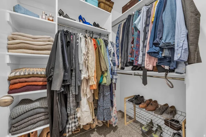 Custom closet system featuring multiple shelves, hanging rods, and an integrated shoe rack
