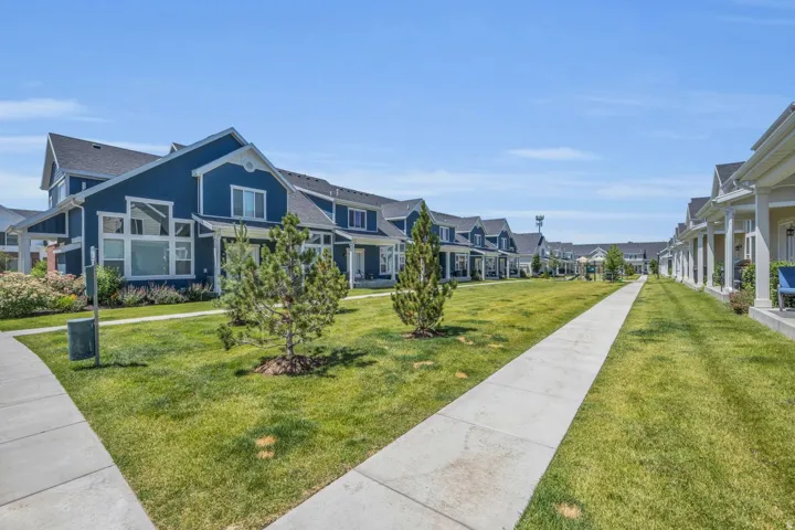 Community green space with a concrete pathway and mature landscaping
