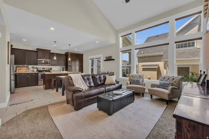 Open concept living area featuring a vaulted ceiling and expansive windows