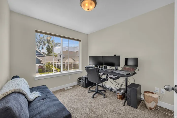 Recessed lighting fixture, light neutral wall paint, carpeted flooring, and a large window with white trim