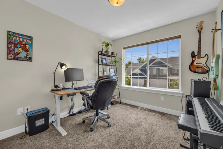 Neutral wall paint, carpet flooring, and a large multi-pane window