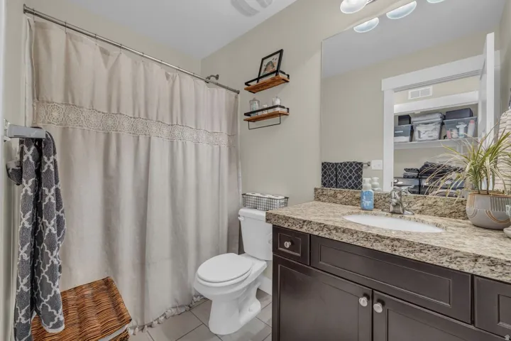 Spacious vanity with a stone countertop and an undermount sink