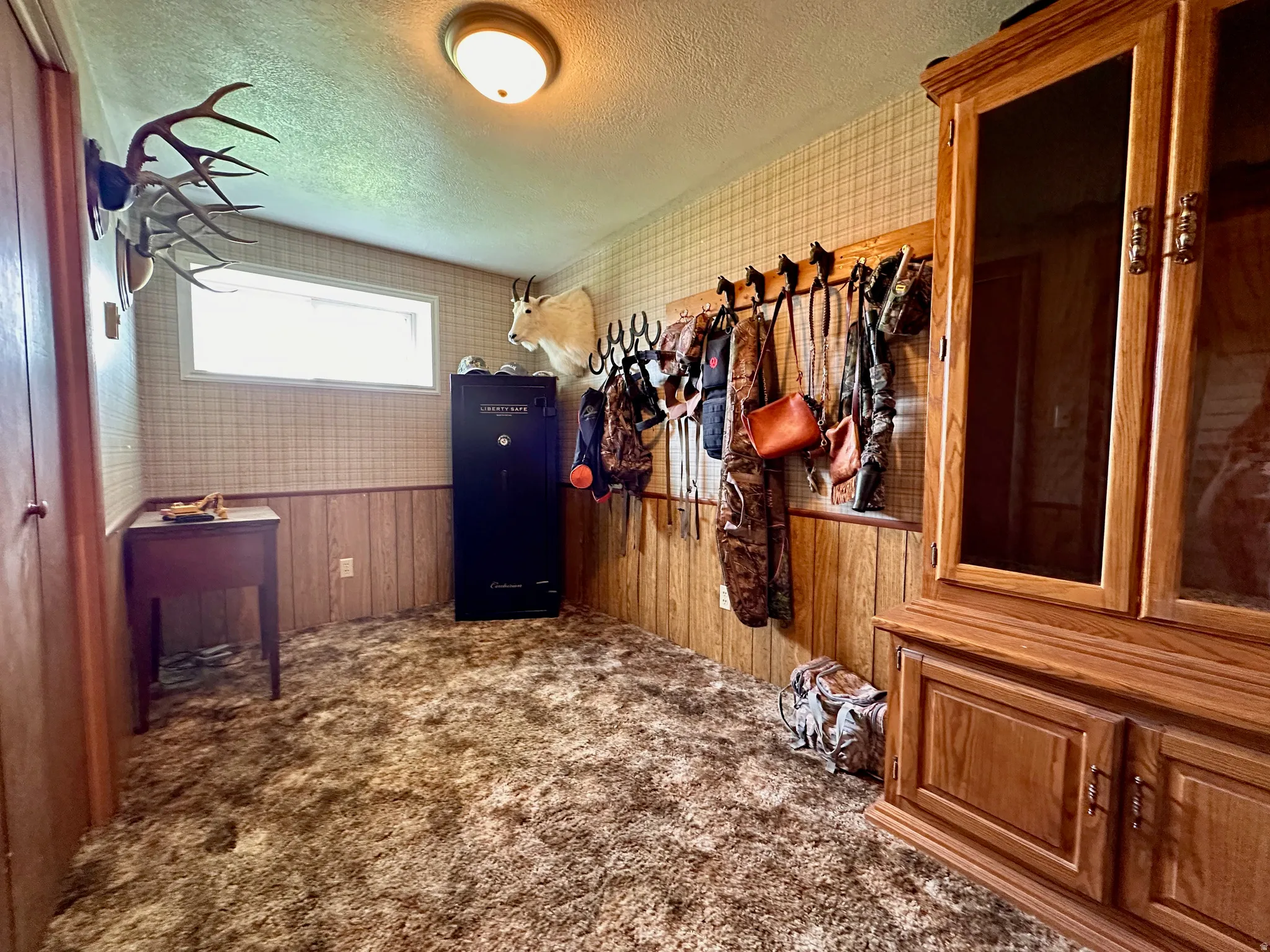 Wood-paneled wainscoting and coordinating textured wallpaper