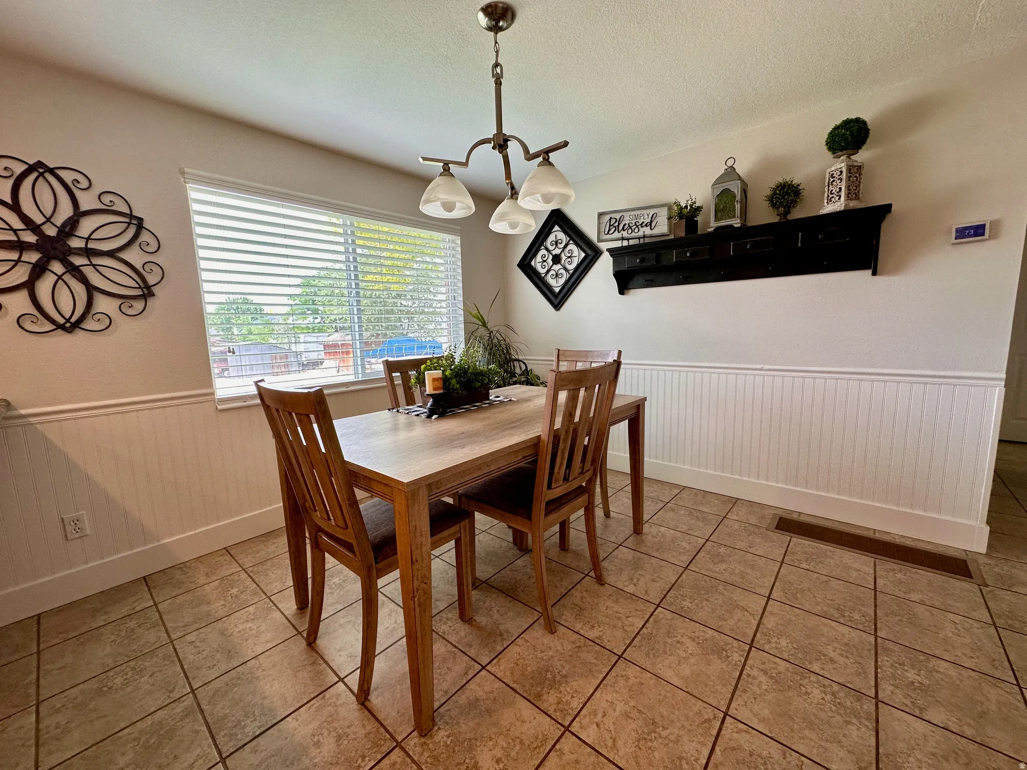 Recessed lighting, tiled flooring, beadboard wainscoting, window with blinds, and a built-in shelf