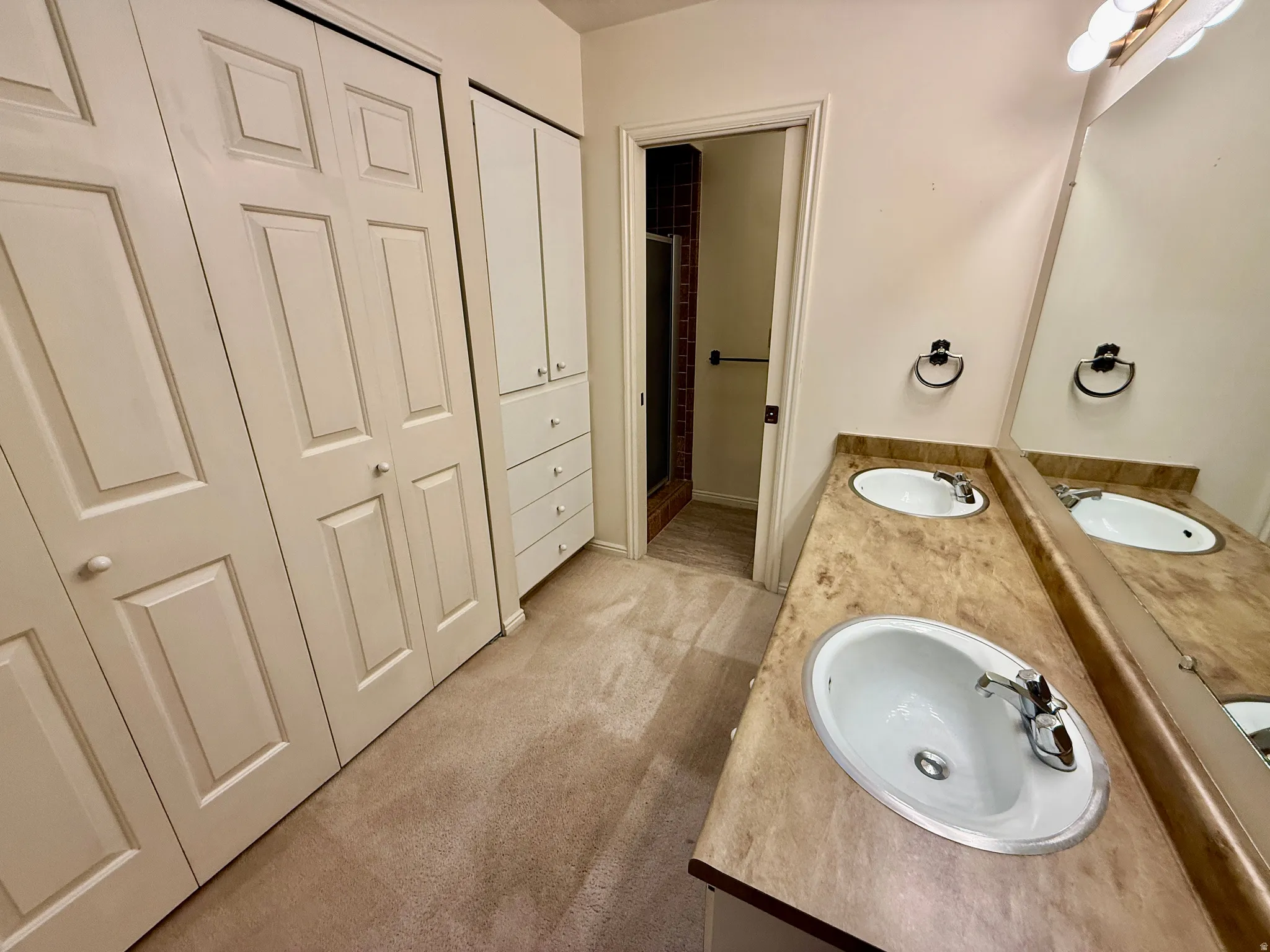 Master Bathroom with his and her closets, double vanity, and walk-in shower.