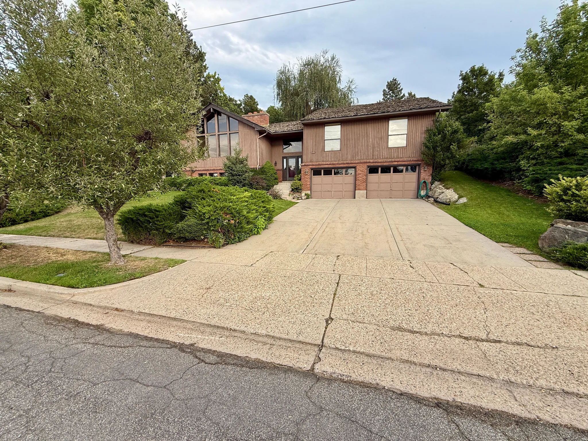 Brick Wood-sided exterior with integrated two-car garage