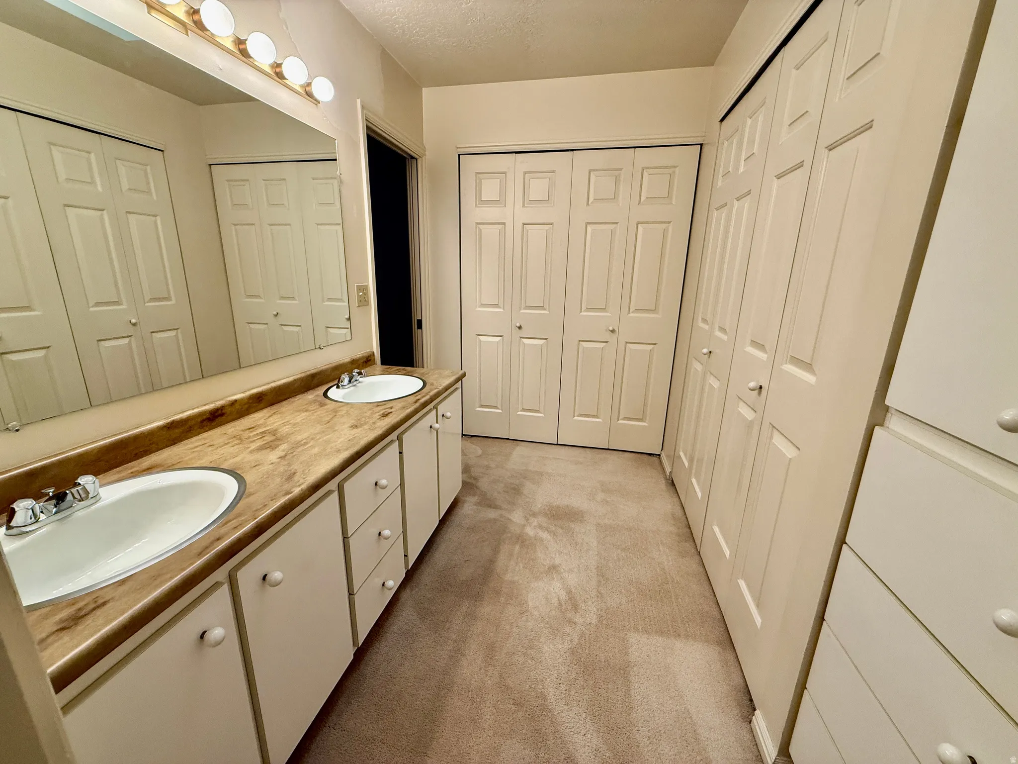 Master Bathroom with his and her closets, double vanity, and walk-in shower.
