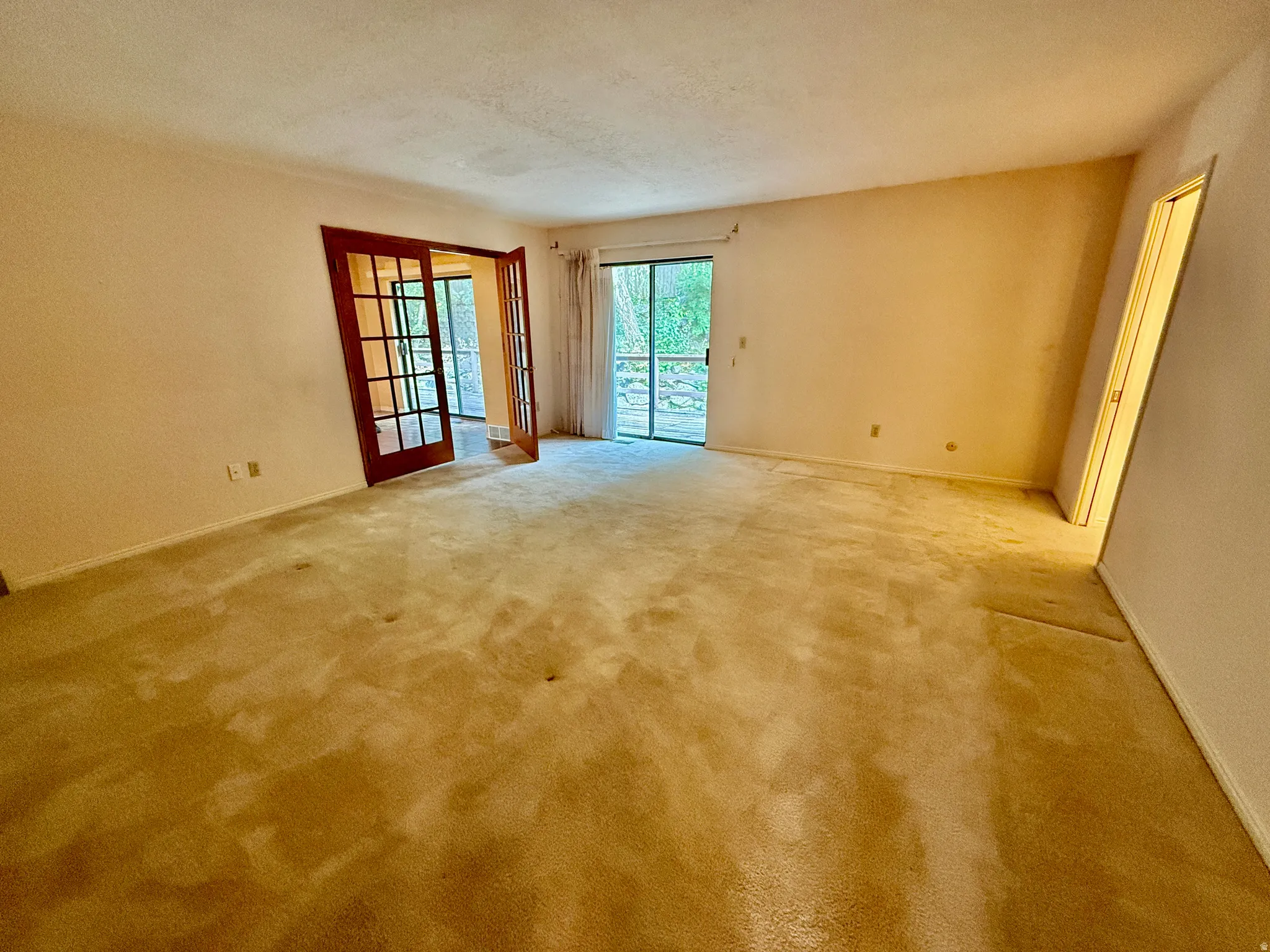 Enormous Master bedroom with sliding glass doors to deck, french doors, double closets, and master bath.