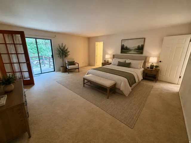 Enormous Master bedroom with sliding glass doors to deck, french doors, double closets, and master bath.