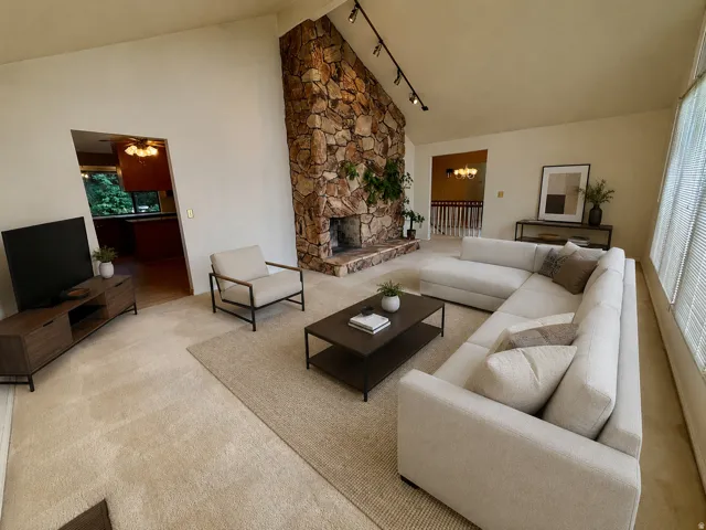 Vaulted ceilings complement the stone fireplace and hearth, Expansive windows and natural light