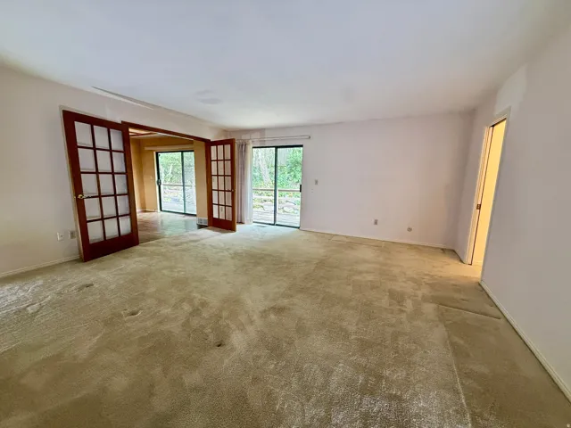 Enormous Master bedroom with sliding glass doors to deck, french doors, double closets, and master bath.