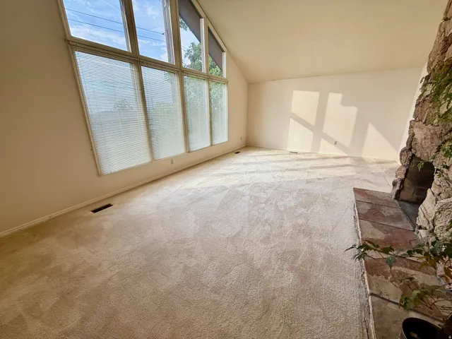 Bright, sun-filled room with large multi-pane windows flooding the space with natural light