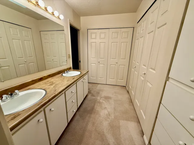 Master Bathroom with his and her closets, double vanity, and walk-in shower.