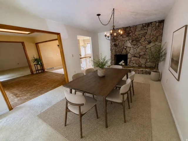 Stone-clad fireplace with mantel, recessed firebox, and hearth