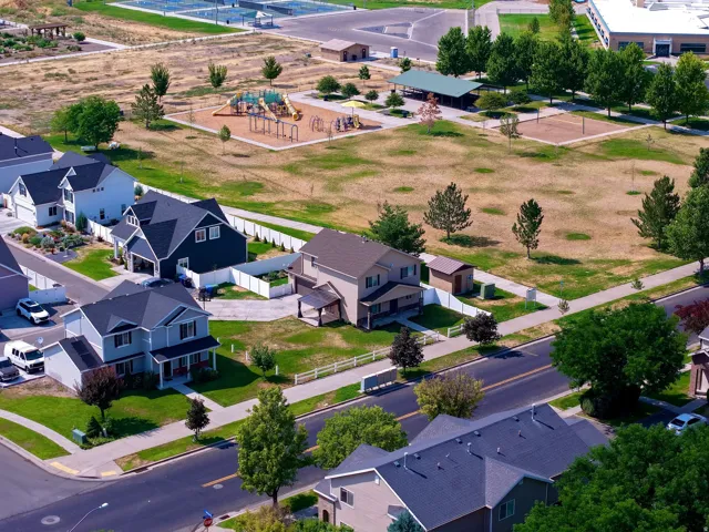 Community park with a playground, covered picnic area, and sports courts