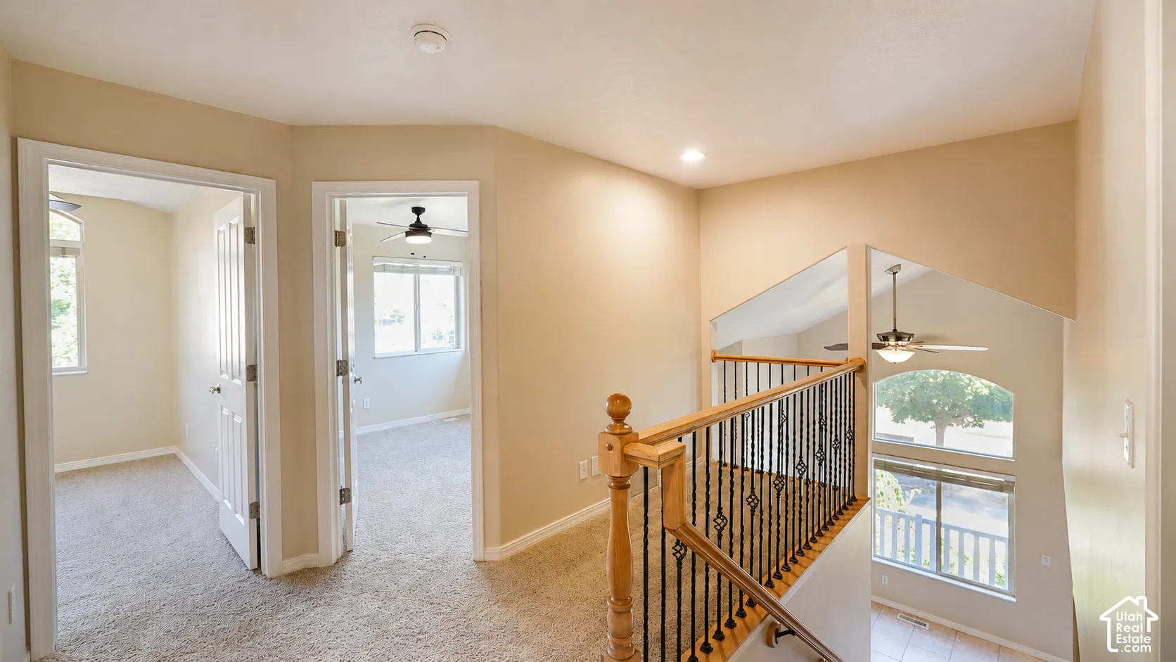 Two separate rooms with carpet flooring and windows