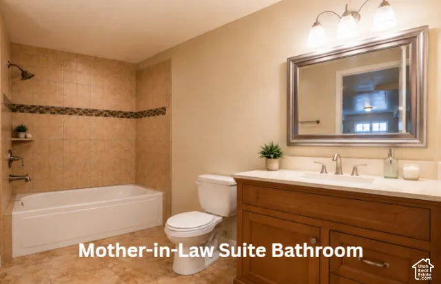 Bathroom featuring a built-in tub with tile surround, wood-finish vanity with a single basin sink, and a framed mirror