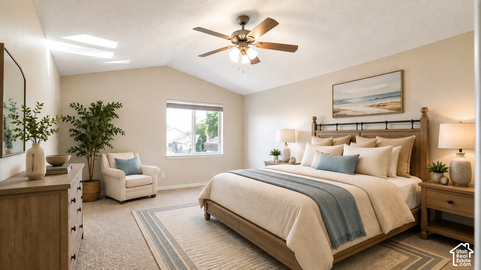 Vaulted ceiling, ceiling fan, window with roller shades, neutral wall paint, and light-colored carpeting