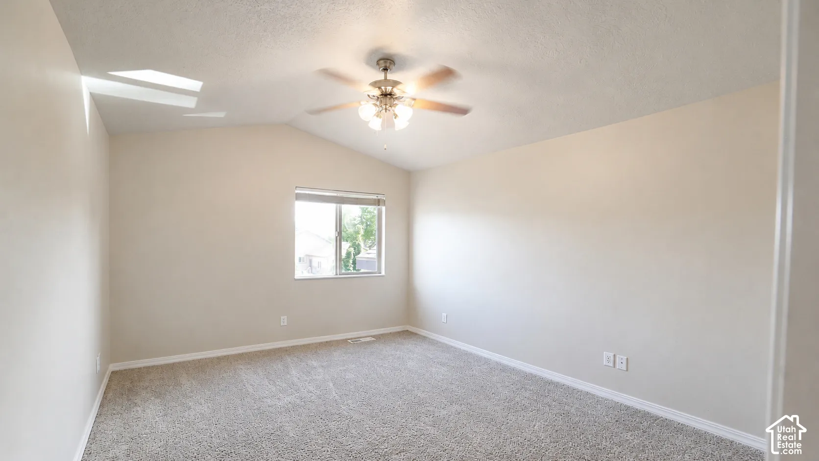 Sloped ceiling with an attached ceiling fan and light fixture