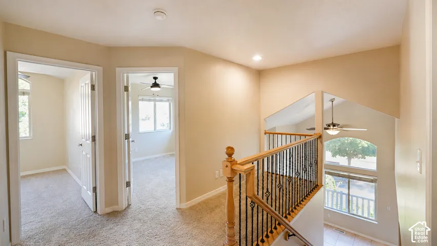 Two separate rooms with carpet flooring and windows