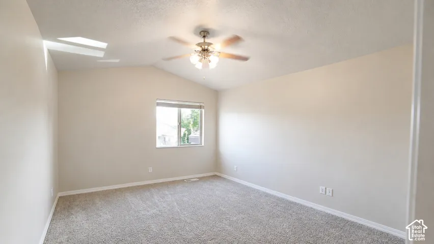 Sloped ceiling with an attached ceiling fan and light fixture