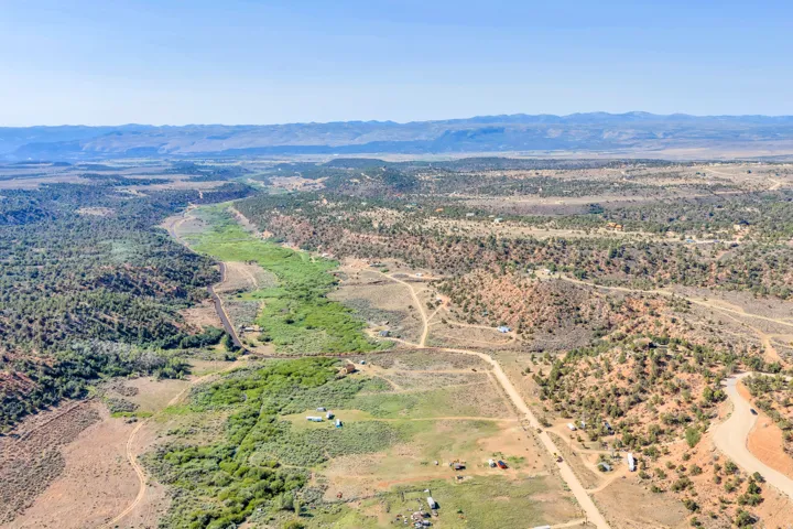 Expansive terrain with natural vegetation and distant mountain ranges