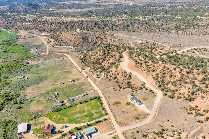 Expansive rural landscape featuring a winding road and varied topography
