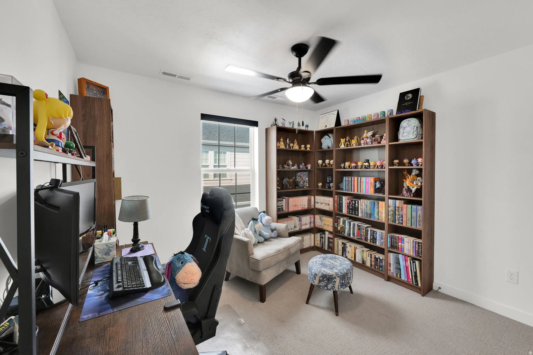 Neutral wall colors, recessed window, ceiling fan with integrated lighting, built-in shelving, and carpeting