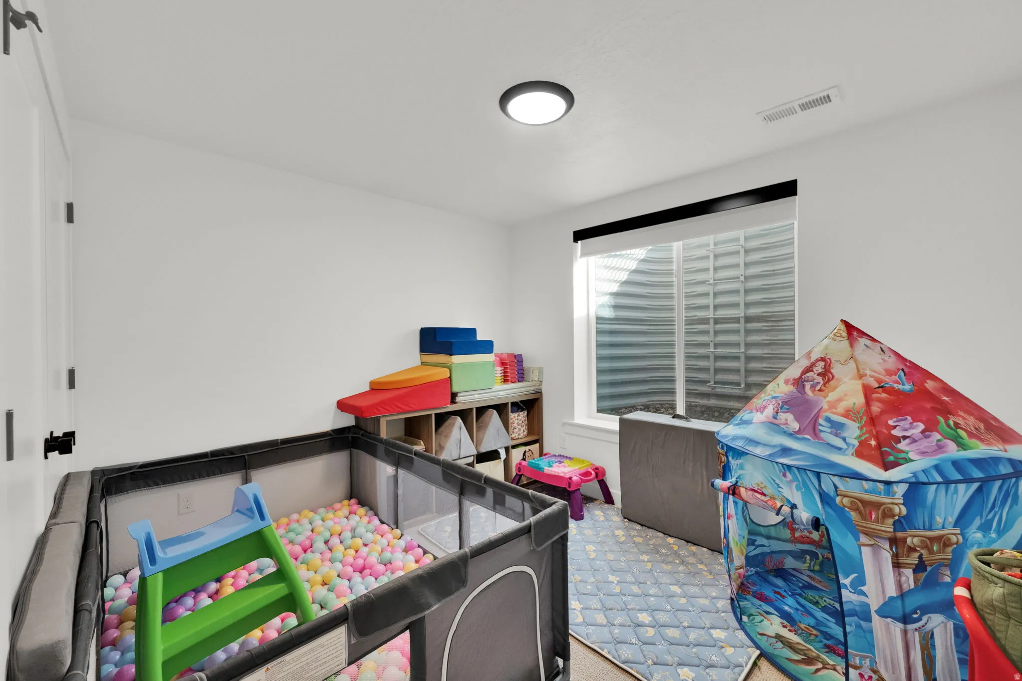 Recessed window with white trim, flush mount ceiling light, and white walls