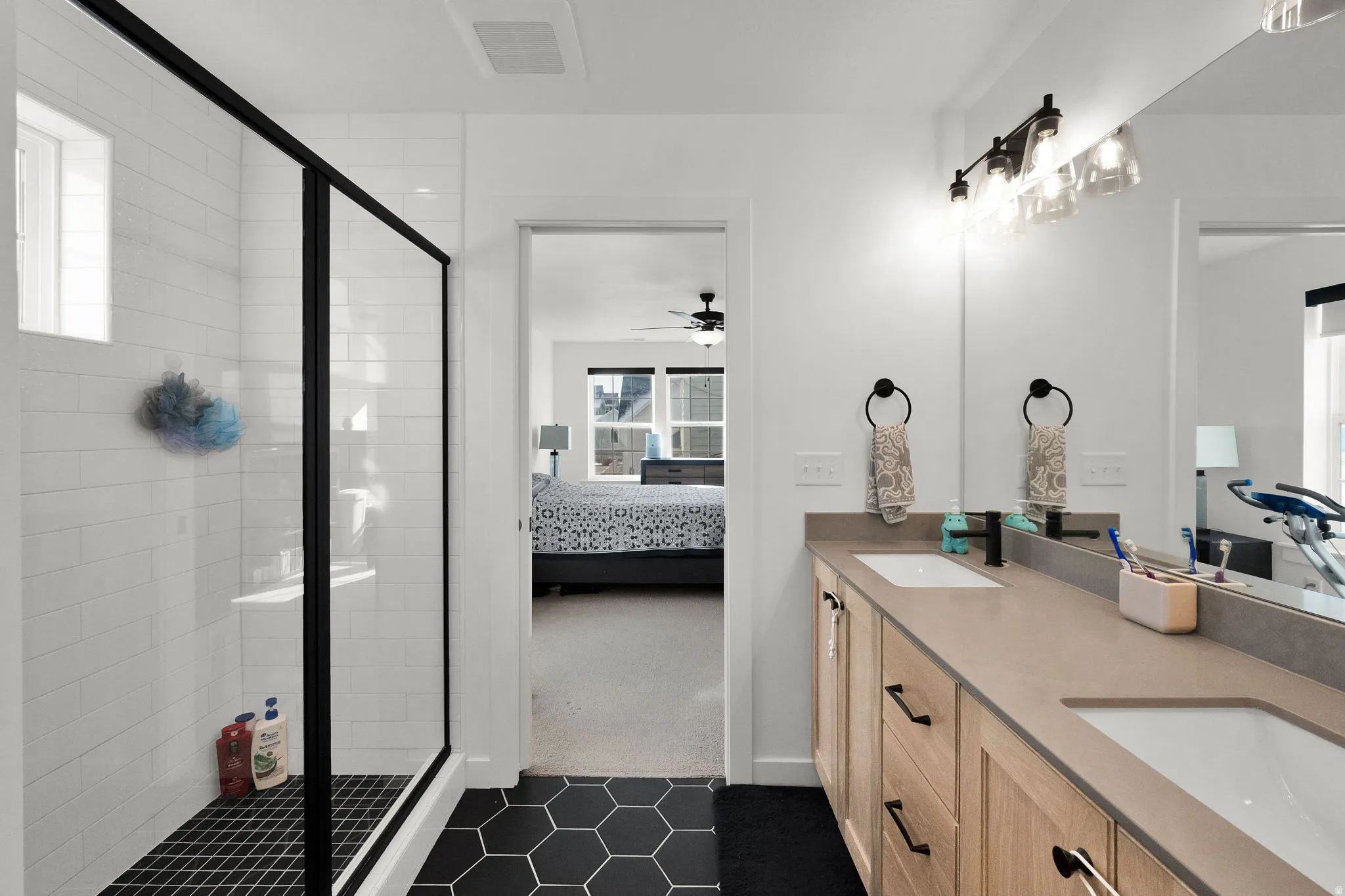 Double vanity with integrated sinks and wood-finish cabinetry