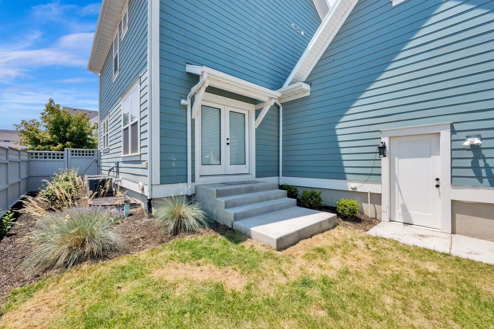 Blue horizontal siding exterior with white trim