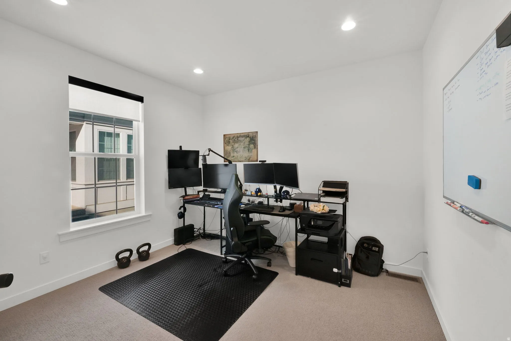 Recessed ceiling lighting, white walls, carpeted flooring, and a double-hung window