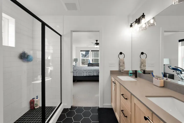 Double vanity with integrated sinks and wood-finish cabinetry