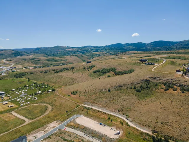 Expansive rolling terrain with distant mountain backdrop