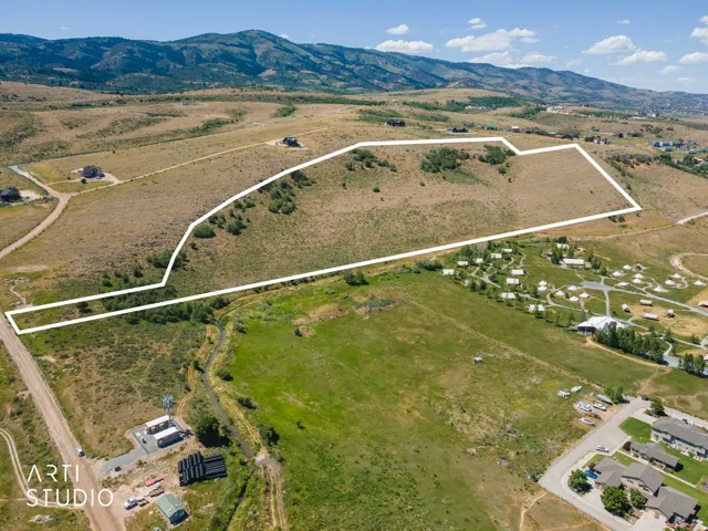 Expansive land parcel featuring natural terrain and distant mountain backdrops
