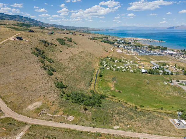 Expansive land parcel featuring natural terrain, partial green space, and visible road access
