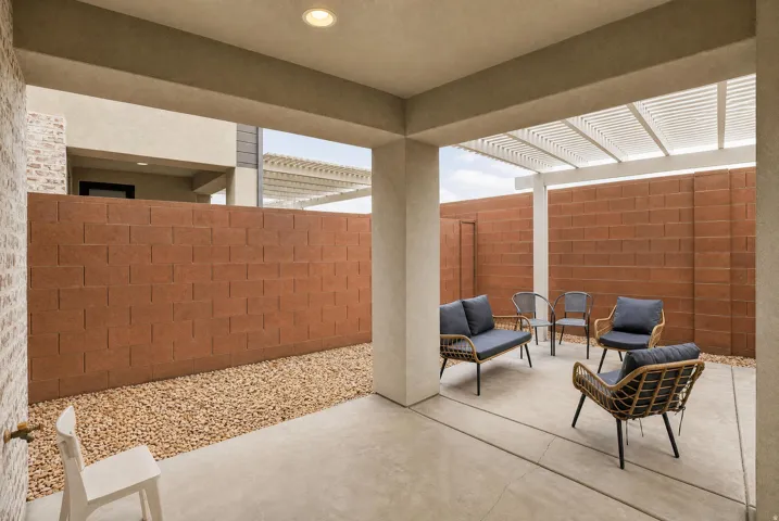 Covered patio with recessed lighting, concrete flooring, decorative gravel, and a slatted pergola