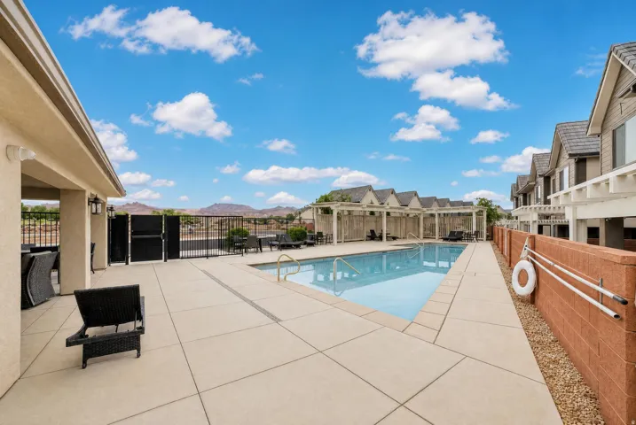 Outdoor swimming pool with integrated steps, surrounded by a concrete patio