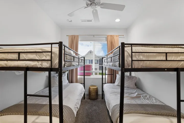 Carpeted room with a ceiling fan, recessed lighting, and a window featuring blinds and drapes